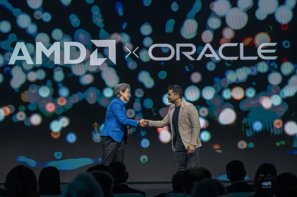 Zástupcovia spoločností AMD a Oracle si podávajú ruky pri oznámení spolupráce na nasadení tisícov GPU AMD pre nový AI superklaster Oracle.
